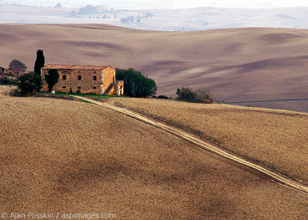 A farmhouse in Tuscany, Italy after the fields have been tilled.
