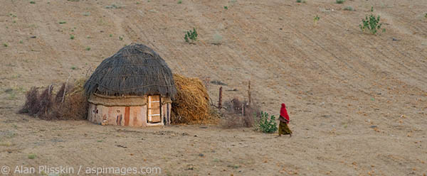 A woman wearing a red sari in the Rajasthan region.