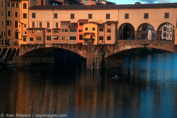 The famous Ponte Vecchio is a bustling marketplace during the day, but first thing in the morning the sculler was all that was moving.