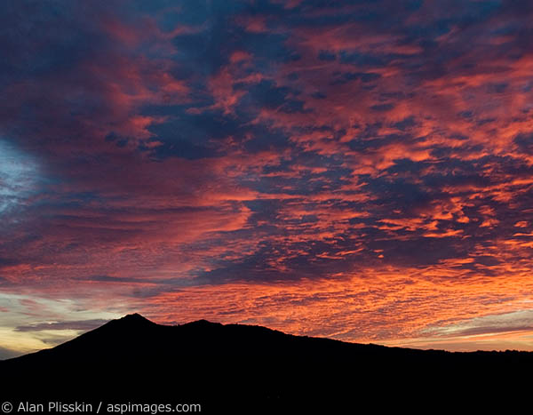 Mt Tamalpias is silhouetted against a colorful evening sky.