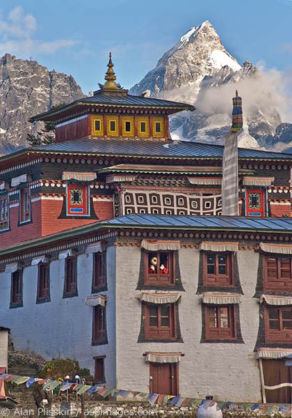 Two monks were blowing conch shells as a call to worship at the monastery.