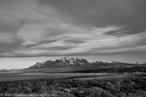 As we driving away from Torres del Paine National Park in Chile the lenticular clouds hovered over the mountains creating his dramatic scene.